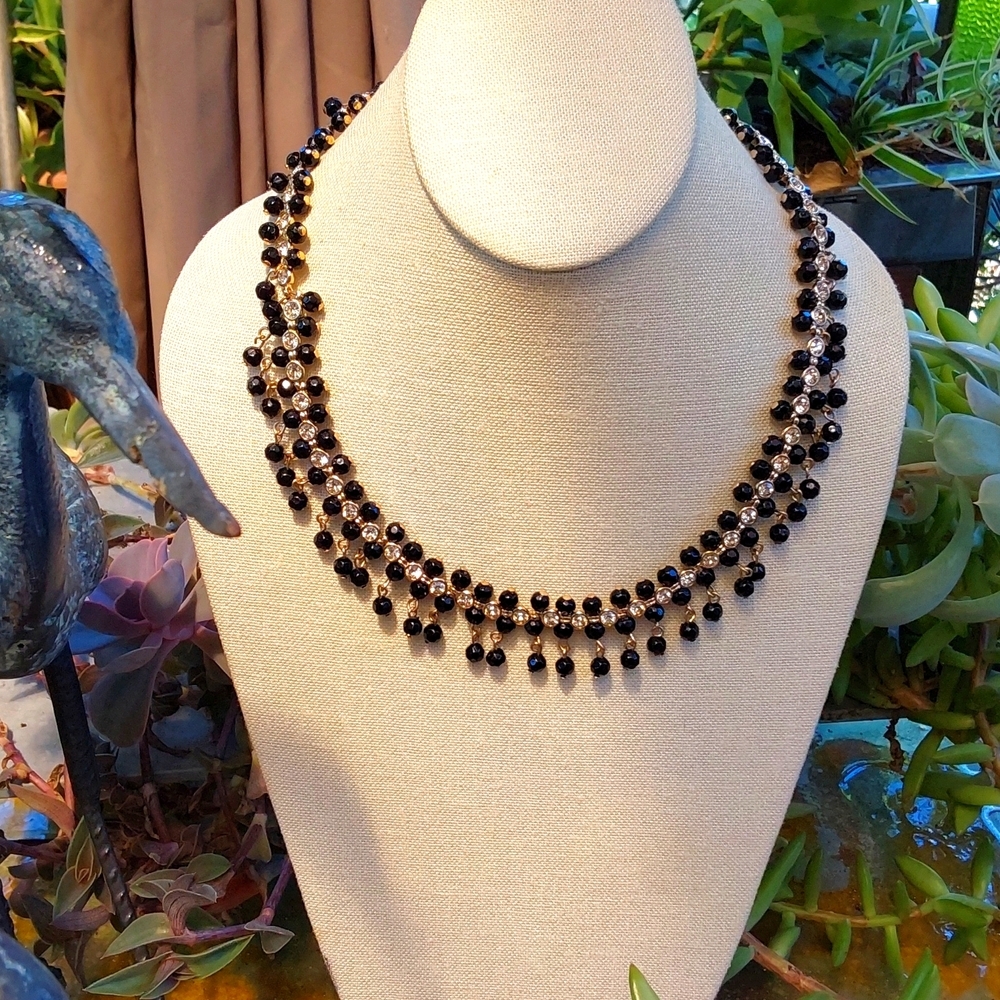 N a t signed black beads with rhinestone on gold tone